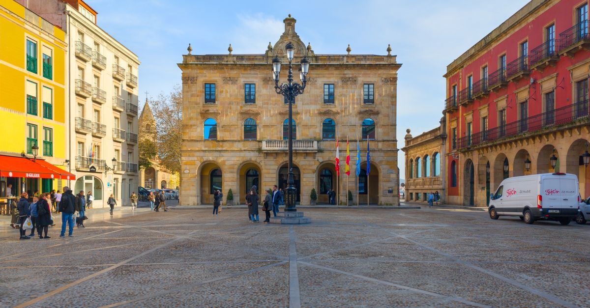 Sunny day in Gijón's Plaza Mayor showcasing Spanish architecture and urban lifestyle.